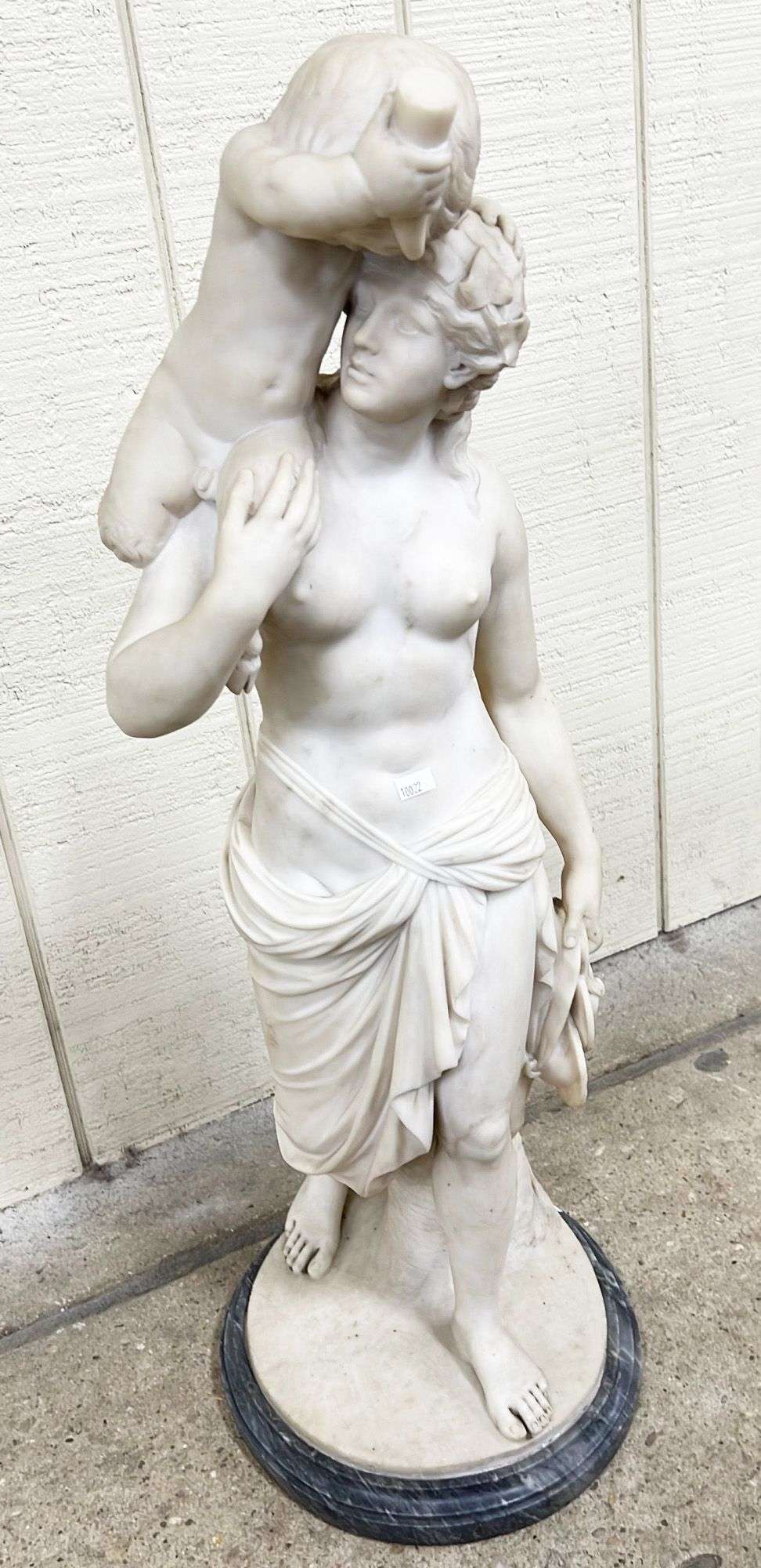 Appraisal: Carved marble classical woman faun sculptureMeasures in height Loss to