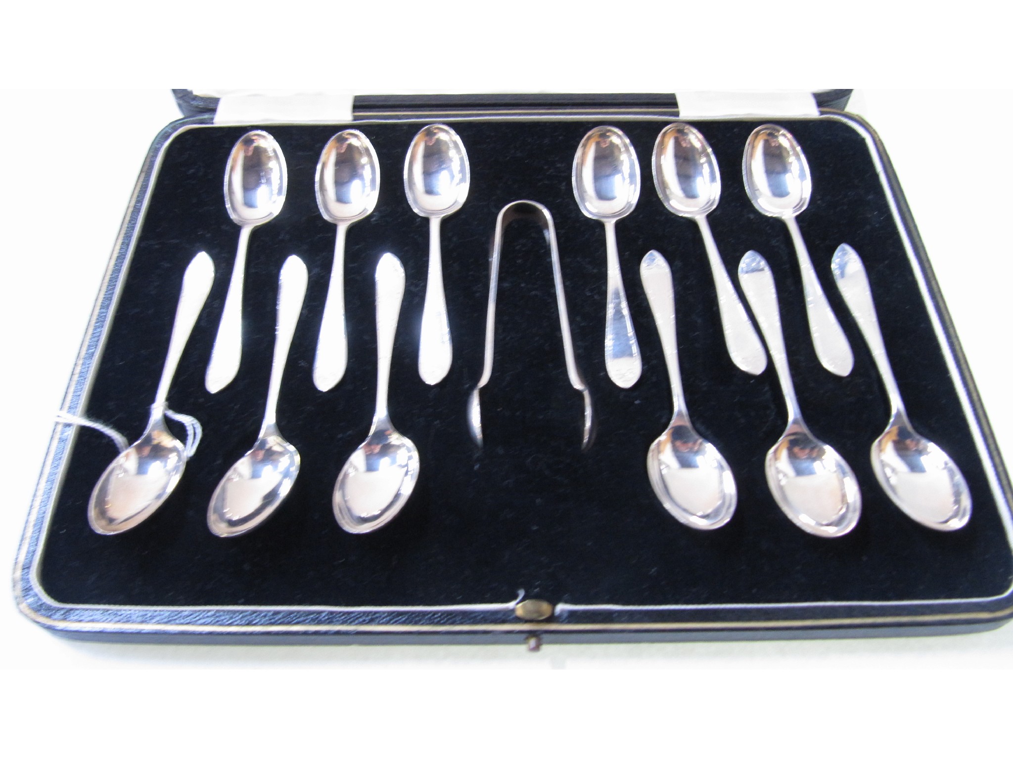 Appraisal: A cased set of twelve silver teaspoons and tongs Sheffield