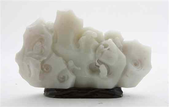 Appraisal: A Carved White Hardstone Boulder depicting a composition of monkeys