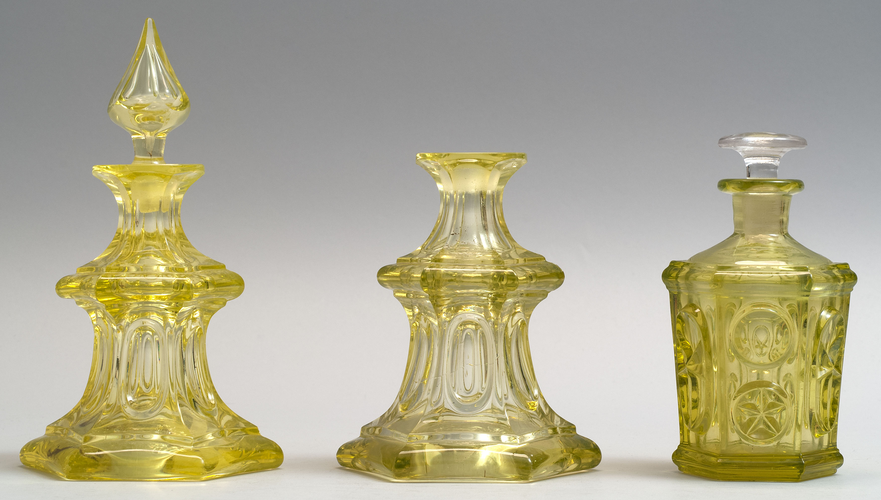 Appraisal: THREE SANDWICH GLASS COMPANY BLOWN-MOLDED COLOGNE BOTTLES Mid- th CenturyTwo