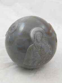 Appraisal: A large chalcedony sphere with Christian images raised in bas