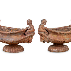 Appraisal: A Pair of Case Iron Oval Footed Planters with Cherub