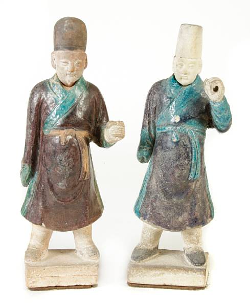 Appraisal: A pair of Chinese turquoise and purple glazed pottery attendant