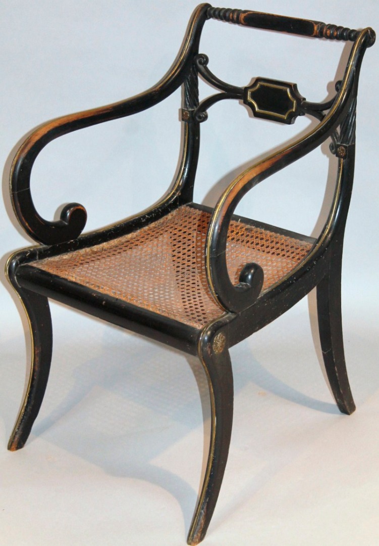 Appraisal: An Regency ebonised carver chair with cylindrical back and cross