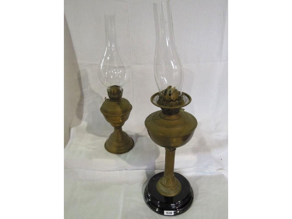 Appraisal: A brass oil lamp on column support together with an