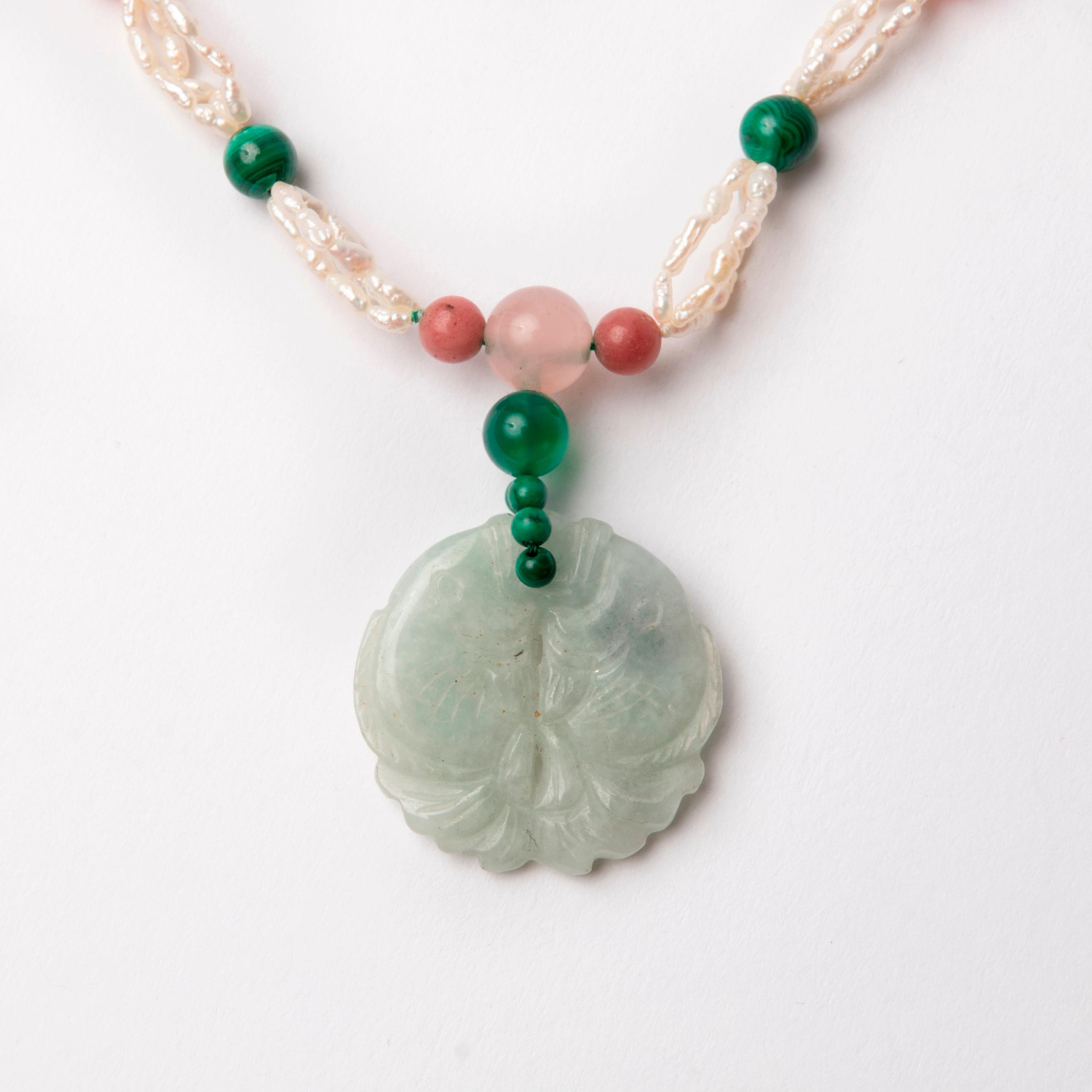 Appraisal: JADEITE DOUBLE FISH NECKLACE Gemstone bead necklace with a Jadeite