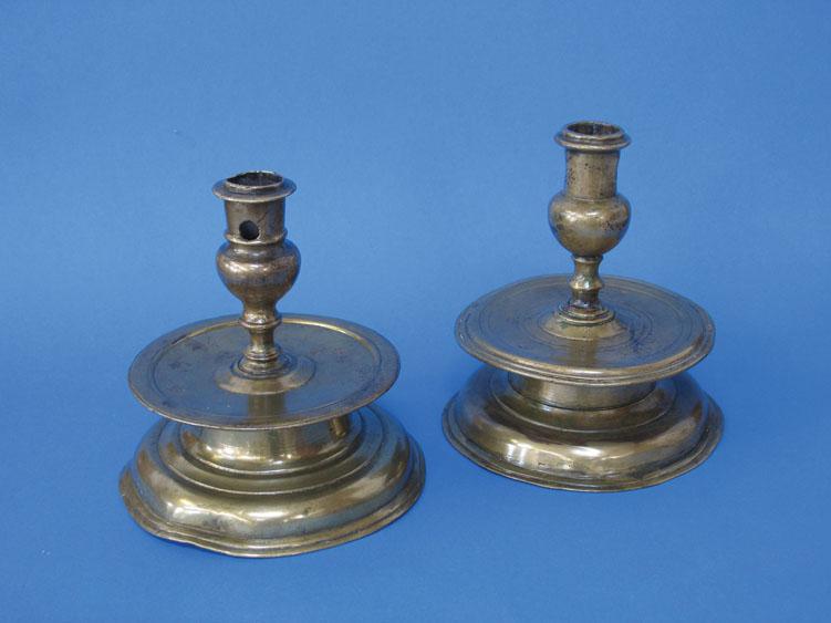 Appraisal: TWO SIMILAR TH CENTURY CAPSTAN TYPE CANDLESTICKS with socket candle