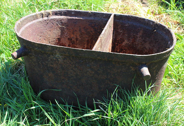 Appraisal: AN OLD OVAL TWO-SECTION CAST IRON WATER TROUGH with lugs