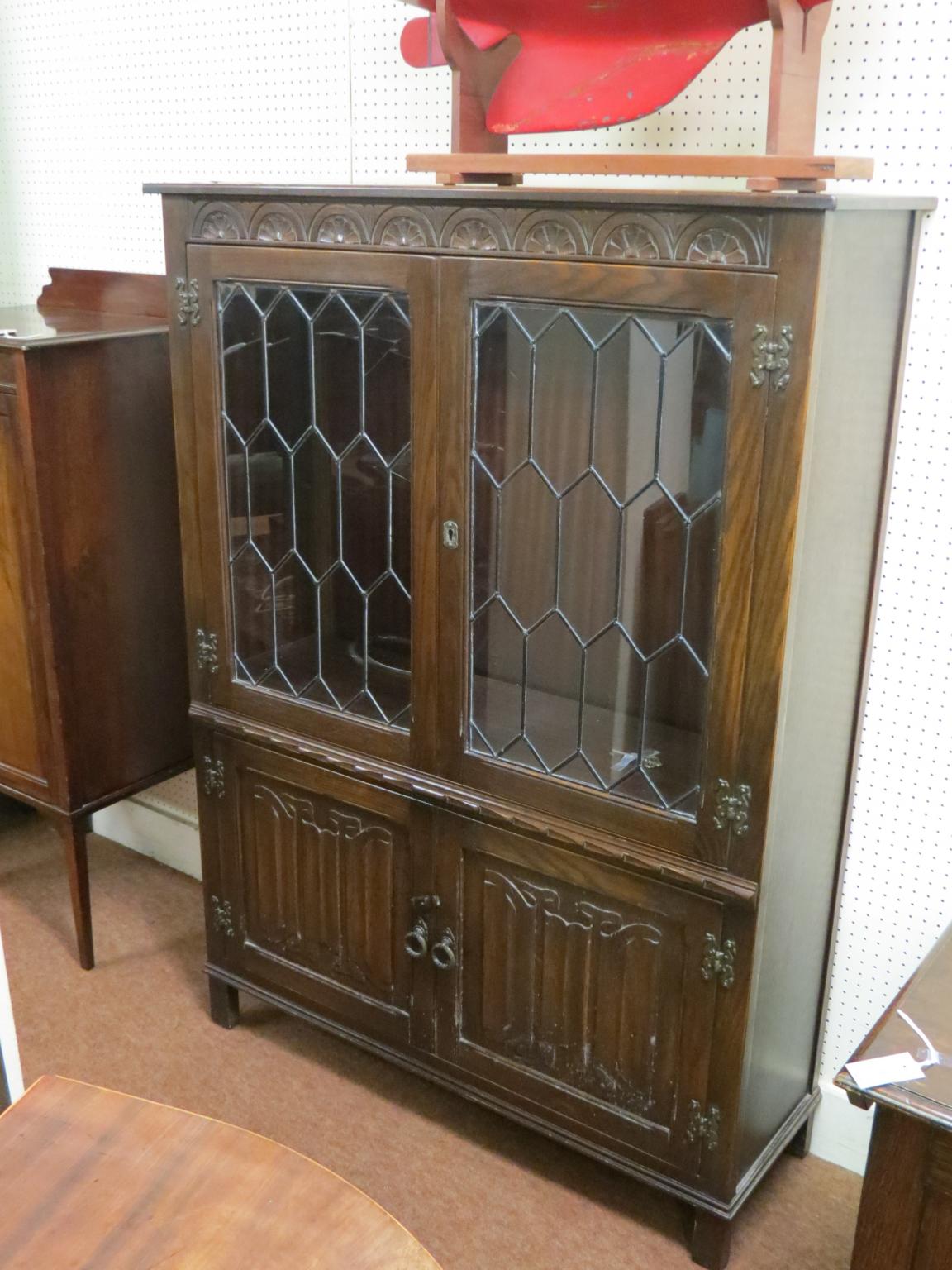 Appraisal: A Jaycee dark oak bookcase pair of leaded glazed doors