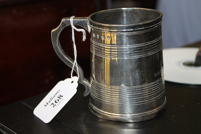 Appraisal: A SCOTTISH SILVER TANKARD of tapering cylindrical form with shaped