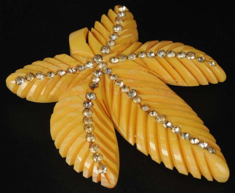 Appraisal: Bakelite Yellow Leaf Clip-On Pin with Rhinestones Condition Excellent Size