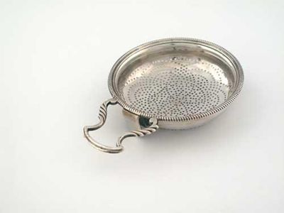 Appraisal: A George III lemon strainer with a gadrooned circular rim