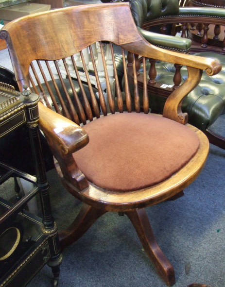 Appraisal: A th century oak office swivel chair with stick back