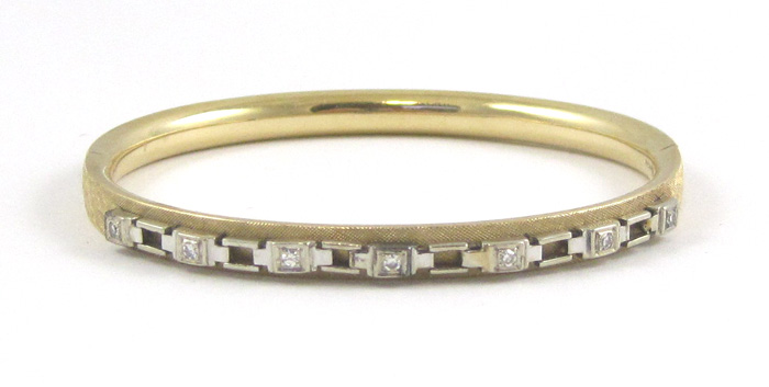 Appraisal: DIAMOND AND FOURTEEN KARAT GOLD BANGLE The oval hinged yellow