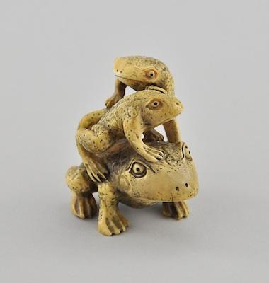 Appraisal: Three Frogs Ivory Netsuke Depicting an adult frog with two