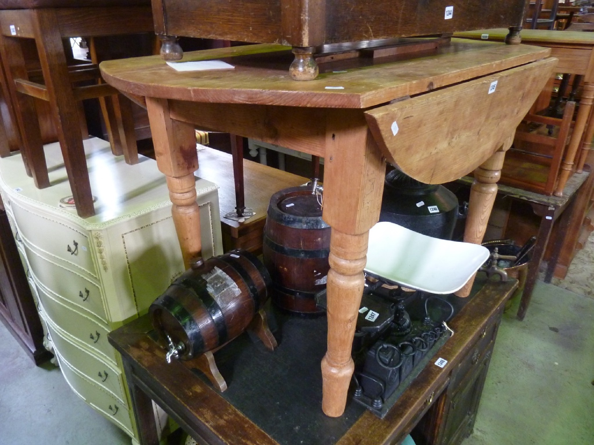 Appraisal: A vintage stripped pine oval drop leaf kitchen table raised