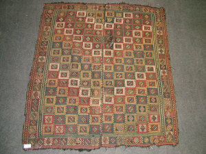 Appraisal: A Verneh carpet with a design of polychrome squares x