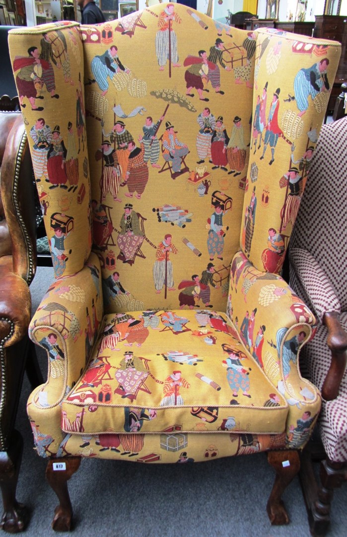 Appraisal: A wing armchair with scroll over arms and cabriole legs