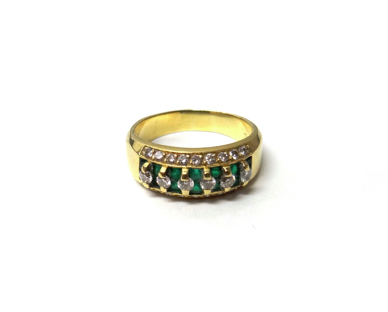 Appraisal: A gold diamond and emerald ring mounted with a row