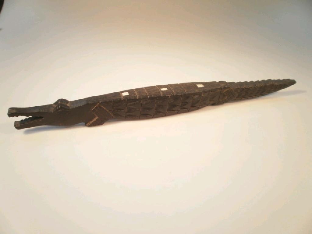 Appraisal: A carved ebony alligator or crocodile inset with bone spines