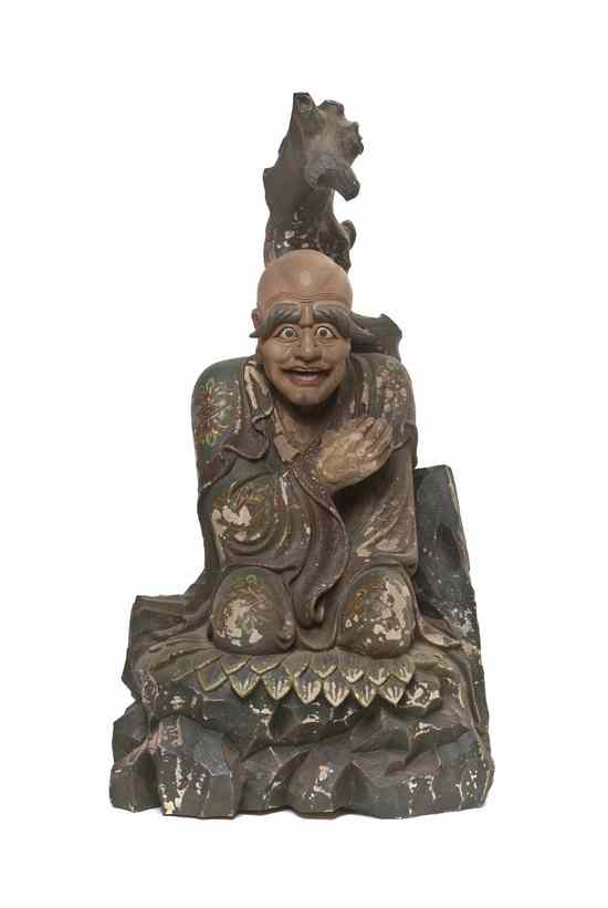 Appraisal: A Carved Wood Figure depicting a kneeling figure in a