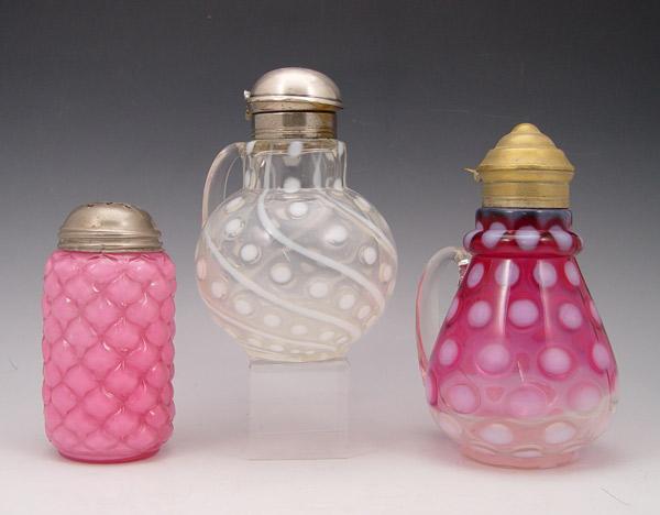 Appraisal: VICTORIAN ART GLASS SYRUPS AND A SUGAR SHAKER Opalescent and