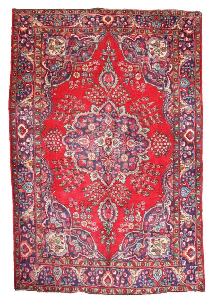 Appraisal: A late Tabriz carpet the red field with indigo cusped