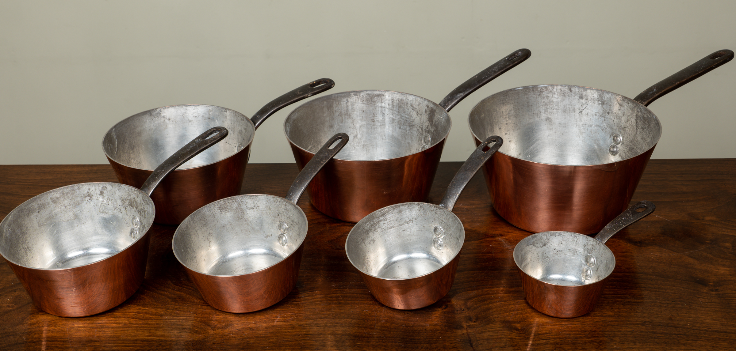 Appraisal: A set of graduated copper pans with tin lining stamped