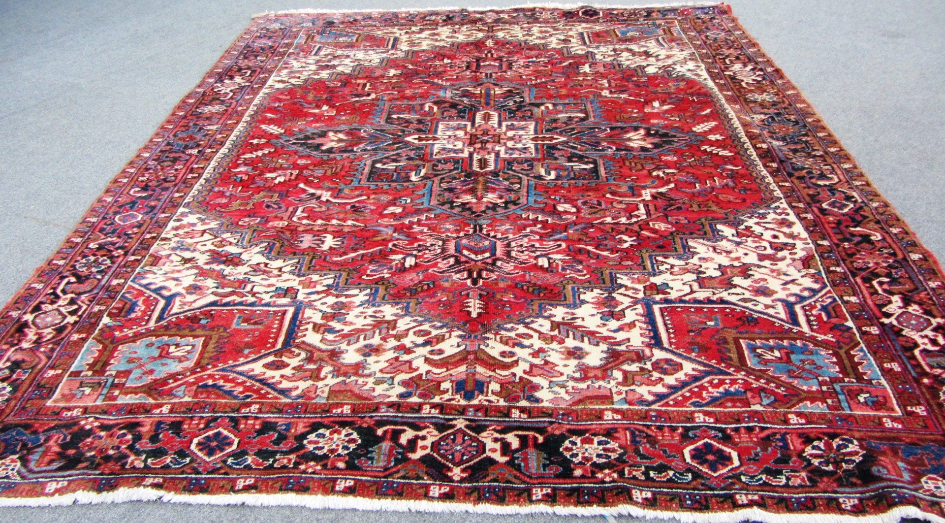 Appraisal: An Heriz carpet Persian the madder field with a bold