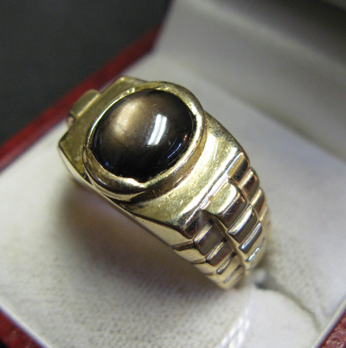 Appraisal: BLACK STAR SAPPHIRE AND FOURTEEN KARAT GOLD SOLITAIRE RING WITH