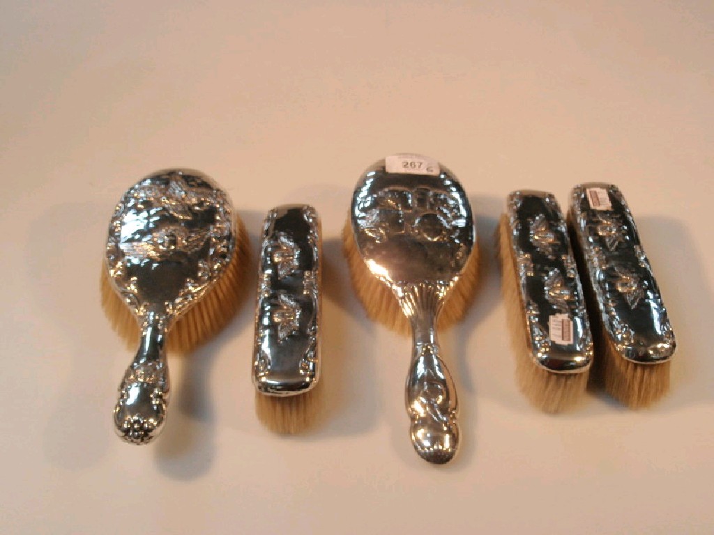 Appraisal: A composite silver dressing table set comprising two hair brushes