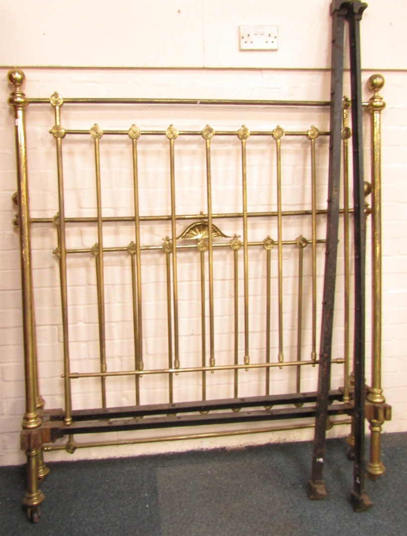 Appraisal: A Victorian brass double bed with iron base and side