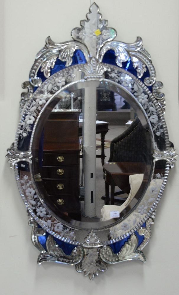 Appraisal: Oval Venetian mirror having fleur-de-lis top and blue mirror background