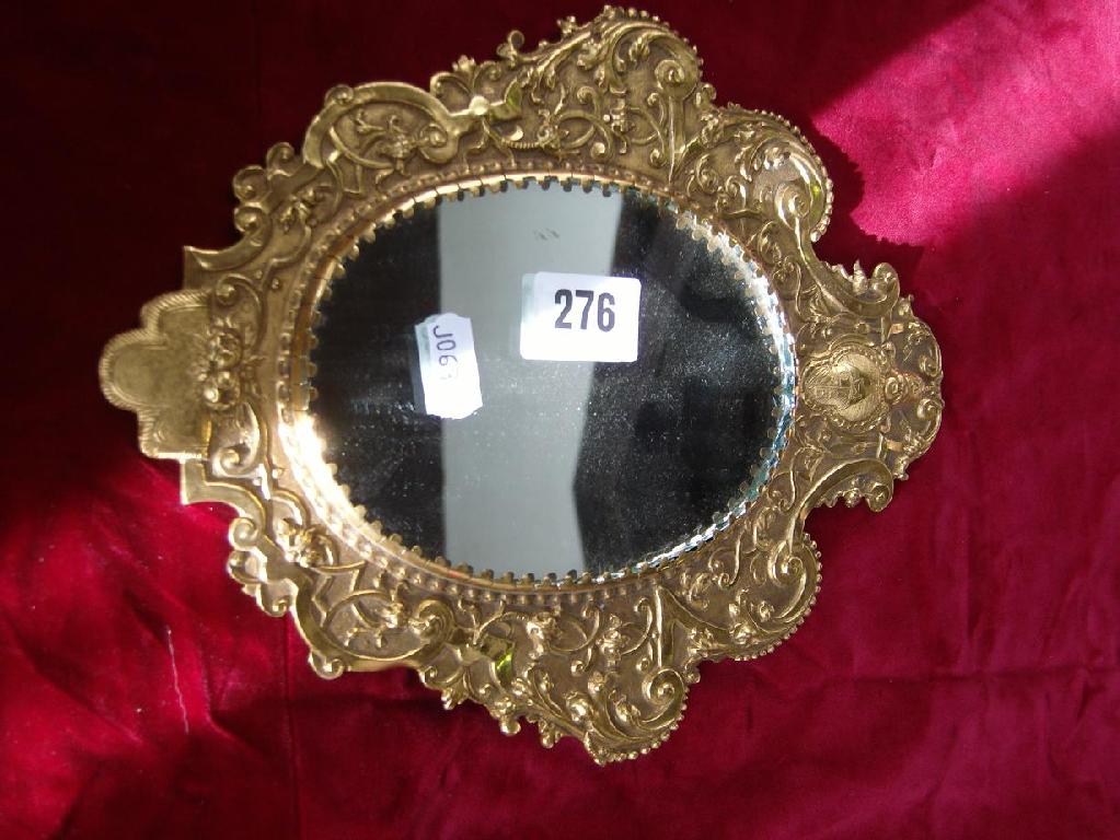 Appraisal: A brass mirror frame of oval form with embossed and