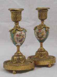 Appraisal: A pair of gilt metal candlesticks with ceramic bodies having