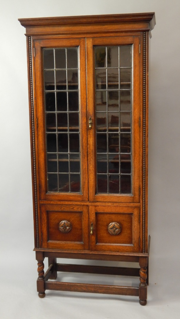 Appraisal: An oak two door bookcase with leaded glazed doors cm