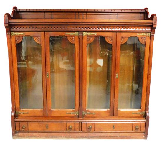 Appraisal: Bookcase Eastlake c gallery top with carved linear motif supports