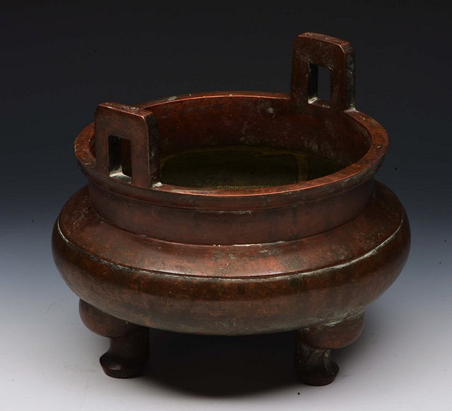 Appraisal: A CHINESE BRONZE TWO HANDLED CENSER th Century cm diameter