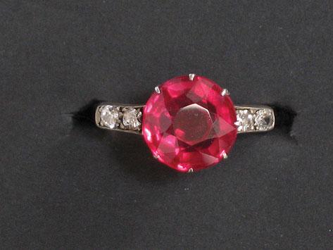 Appraisal: A RED STONE AND DIAMOND DRESS RING the central round-cut