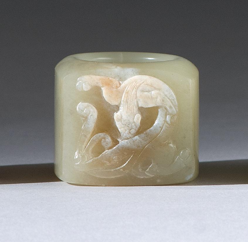 Appraisal: CELADON AND CHICKEN-BONE JADE THUMB RING th CenturyWith relief qilin