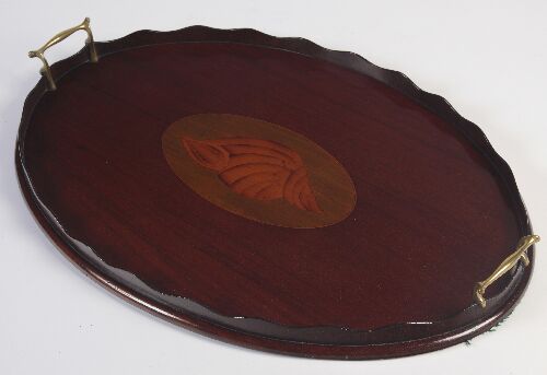 Appraisal: An Edwardian mahogany tray of oval form with waved gallery