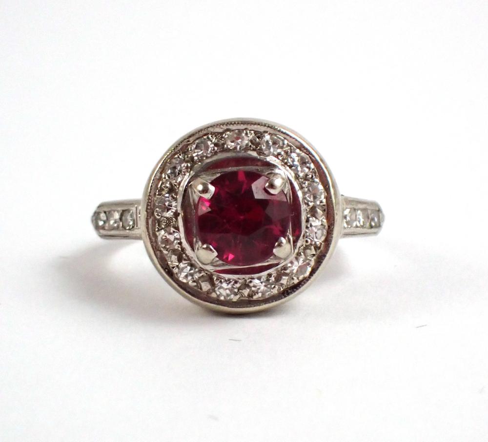 Appraisal: DIAMOND SYNTHETIC RUBY AND PLATINUM RING centering a round-cut lab