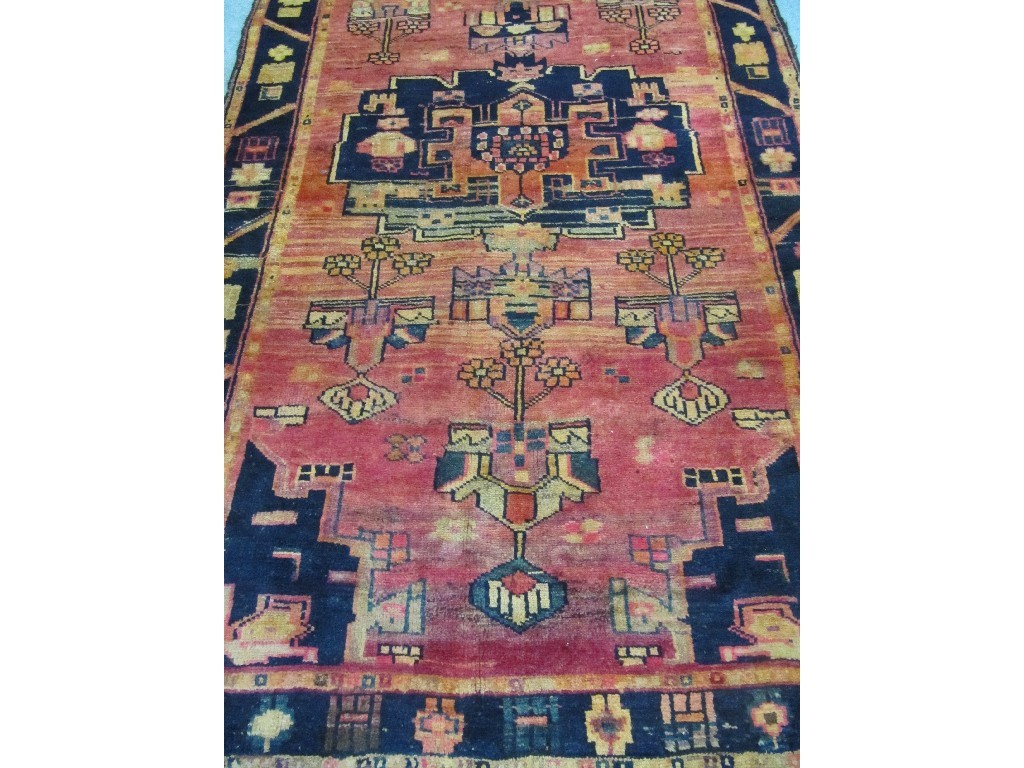 Appraisal: Persian floor rug on an orange ground