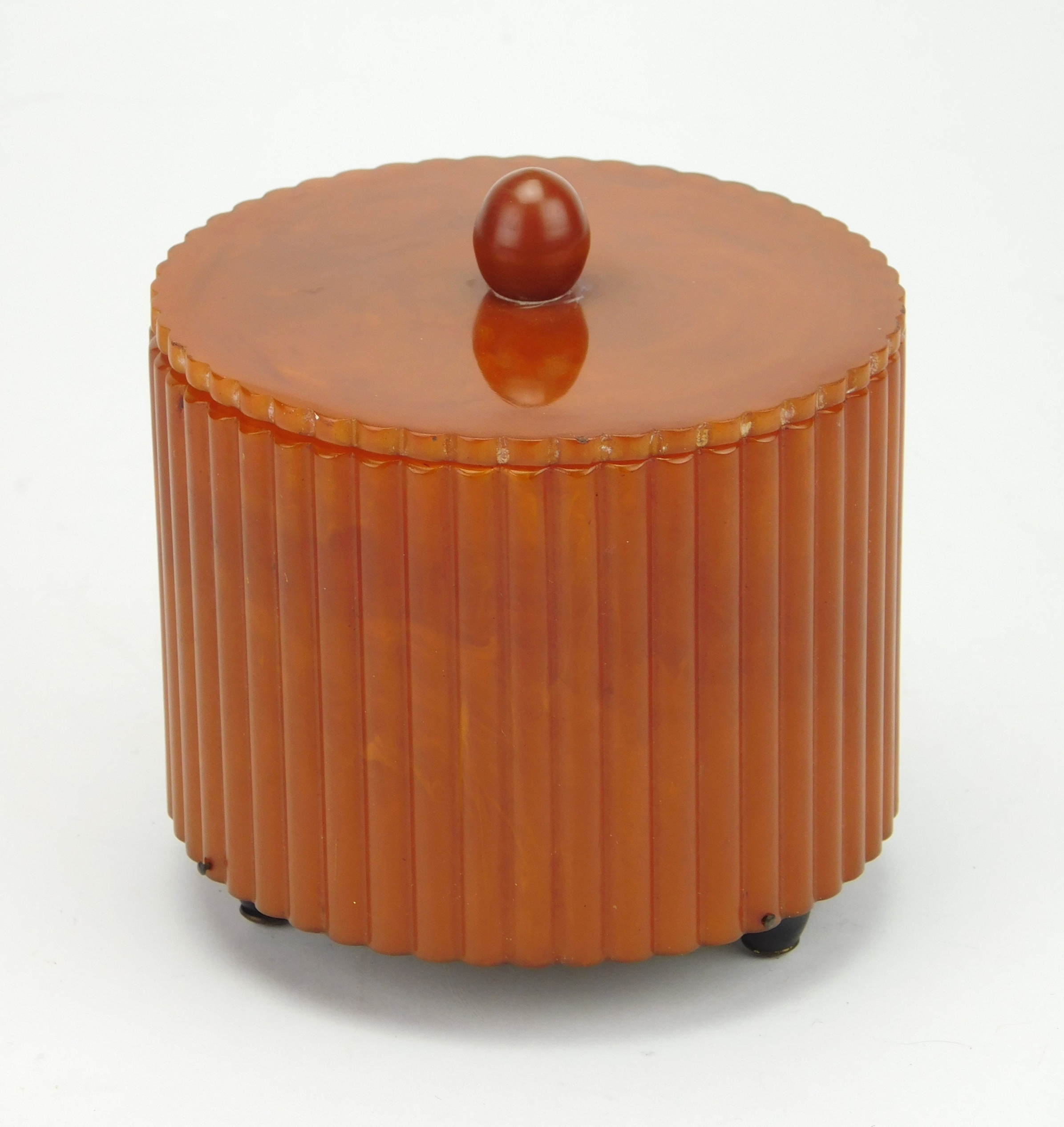 Appraisal: Catalin Bakelite round ribbed dresser powder puff music box with