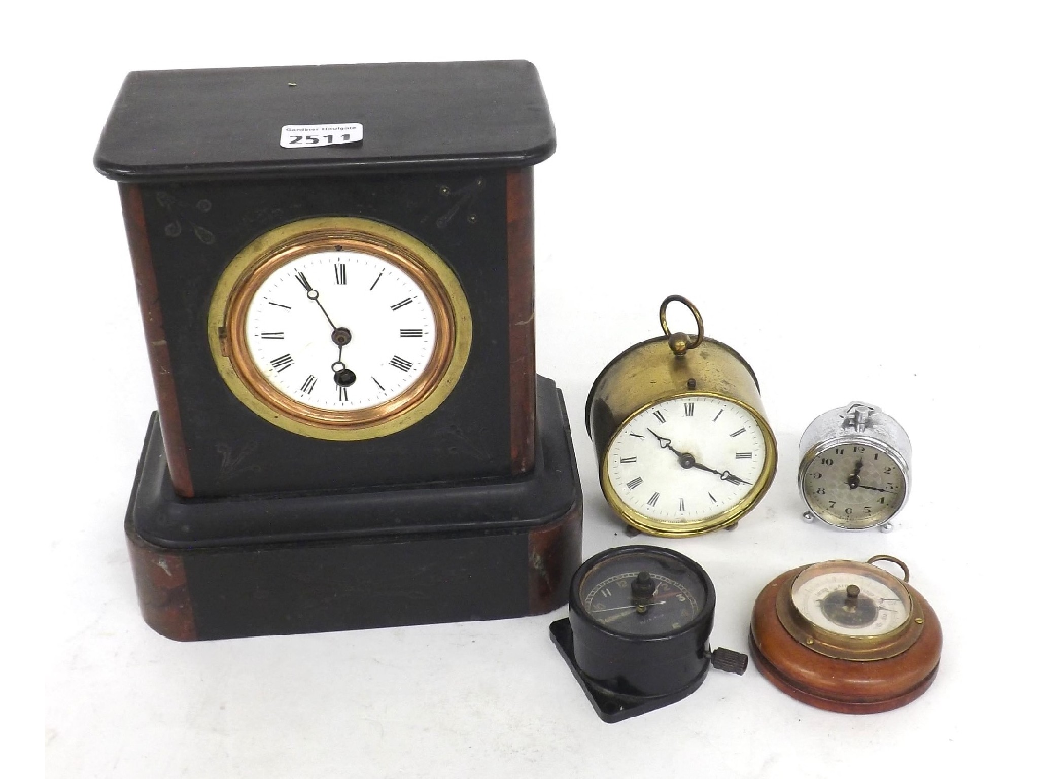 Appraisal: Black slate mantel timepiece brass drumhead timepiece car clock miniature