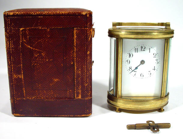 Appraisal: Oval brass cased carriage clock with a swing handle and