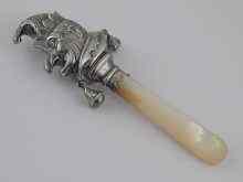 Appraisal: A silver child's ''Punch'' rattle with bells and m o