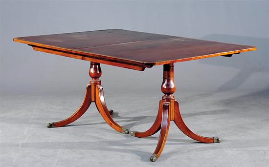 Appraisal: Sheraton style inlaid mahogany pedestal dining table crossbanded top resting