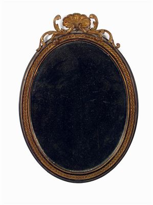 Appraisal: A late th century ebonised and giltwood oval wall mirror