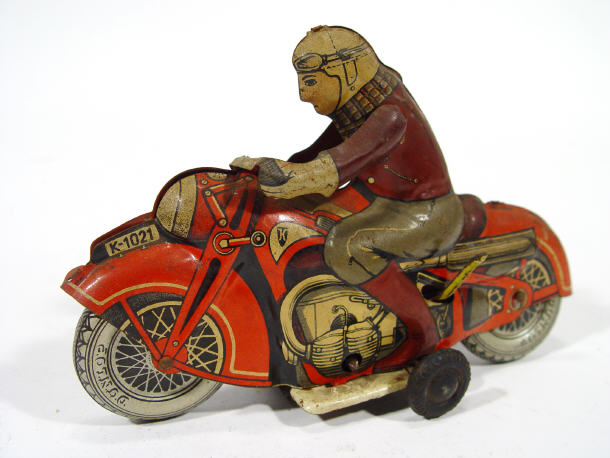 Appraisal: German tinplate clockwork motorcyclist on a red bike cm in